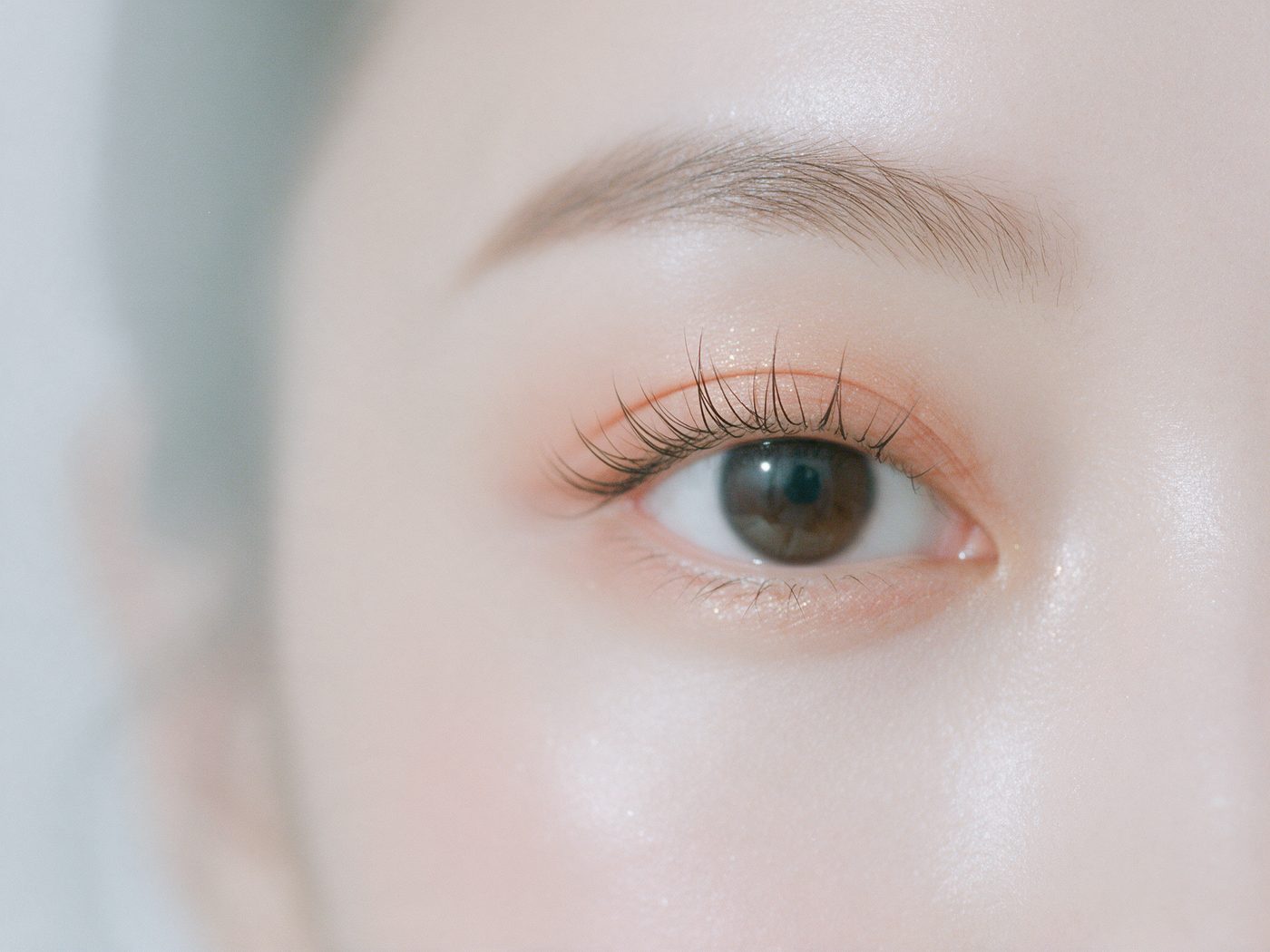 Close-up of wispy individual lash extensions catching the light